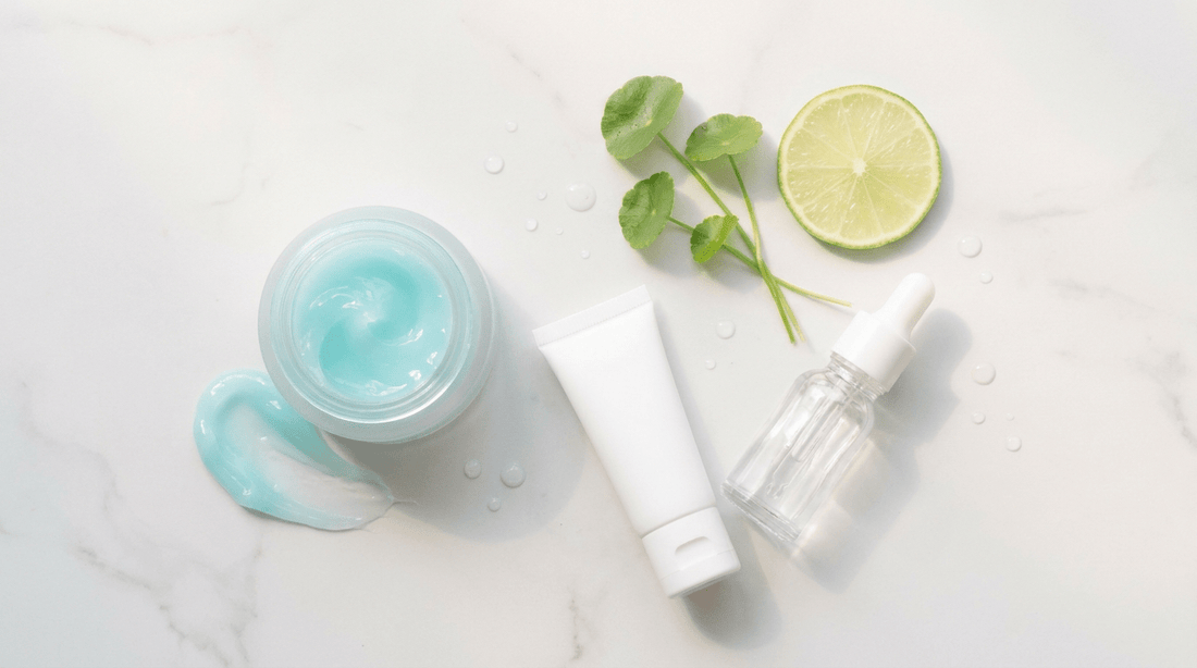 Summer skincare routine for sensitive skin: gel cream texture, sunscreen tube and toner on a marble surface with centella leaves