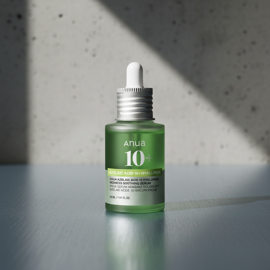 Green skincare serum bottle with dropper on a gray surface and textured wall background